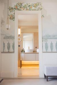 a bathroom with a white sink and a mirror at Hotel Belvedere in Forte dei Marmi