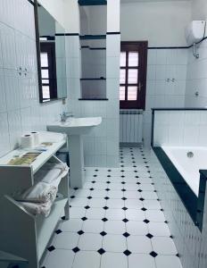 a white bathroom with a sink and a tub at Casa tra gli ulivi a Motta San Giovanni vacanza in Reggio Calabria in Motta San Giovanni