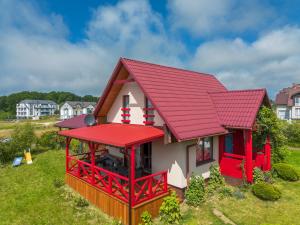 a model of a house with a red roof at Korsarz in Rusinowo
