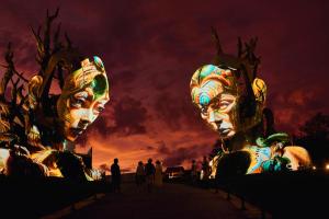 two masks are lit up at night at Nuanu Suites & Accommodations in Tanah Lot