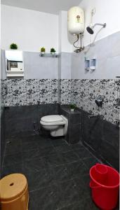 a bathroom with a toilet and a sink at Kanakdhara Homestay in Ujjain +24 photos