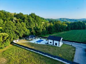 an aerial view of a house with a swimming pool on a field at Villa La Casa Del Sol in Srebrenik