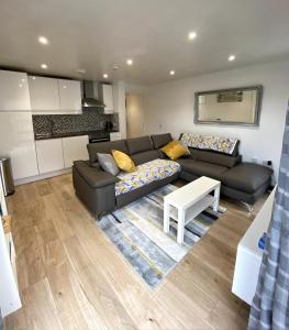 a living room with a couch and a table at Lovely 1 bedroom flat in the heart of Newquay in Newquay