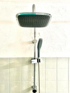 a shower head and a brush in a bathroom at Civico 31 in Terralba +17 photos