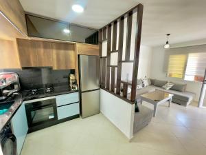 a kitchen with a couch and a table in a room at Résidence CaboBeach in Cabo Negro