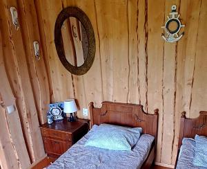 a bedroom with a bed and a mirror on the wall at Imantass in Salacgrīva