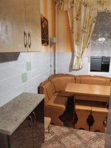 a living room with a couch and a table at Апартаменти на Печерську in Kyiv +2 photos