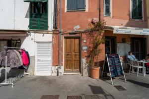 a building with a sign in front of a restaurant at Casa tipica ligure lungomare in pieno centro in Lerici +47 photos