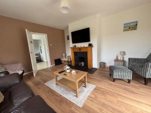 a living room with a couch and a coffee table at Christinas Cottage Downpatrick in Raholp