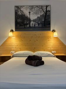 a bed with a towel on top of it at Villa El Hogar in Málaga +48 photos