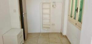 a room with white walls and a tiled floor at Private room in shared flat in Nicosia +43 photos