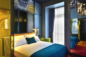 a bedroom with a large bed and a window at Pestana CR7 Lisboa in Lisbon