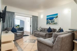 a living room with two couches and a television at Relaxing Seaside Escape at 2 Perissa in Ballito