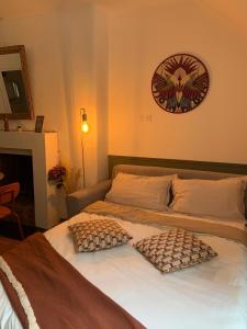 a bedroom with a bed with two pillows on it at La Casa Miguel in Avignon