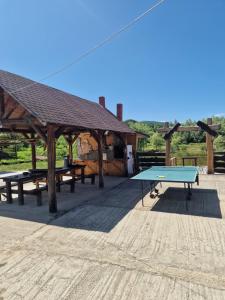 a ping pong table in front of a pavilion at La Ionicã Rozavlea MM in Rozavlea
