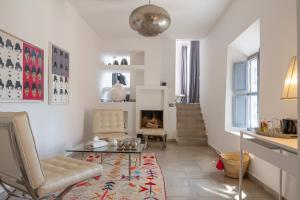 a living room with a chair and a table and a fireplace at Dar Syada Boutique Hotel Marrakech in Marrakech