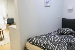 a bedroom with a black and white bed and a table at Happy Inn Sweet Old Town Studio, Self check in, Parking in Vilnius