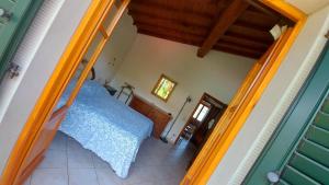 a bedroom with a blue bed in a room at Casa nel Parco delle Foreste Casentinesi in Moggiona