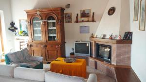 a living room with a couch and a fireplace at Casa nel Parco delle Foreste Casentinesi in Moggiona