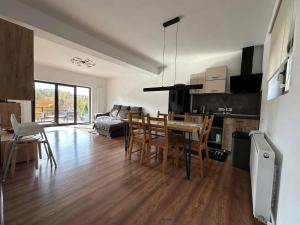 a kitchen and living room with a table and chairs at Green Yard Doftana in Teşila +31 photos