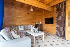 a living room with a couch and a table at Korsarz in Rusinowo