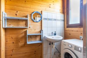 a bathroom with a sink and a washing machine at Korsarz in Rusinowo +31 photos
