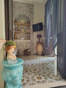 a living room with a vase on a table at Lyssa Holiday Apartments in Taormina