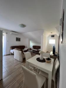a living room with a white table and chairs at Apartman Nina2 in Risan +17 photos
