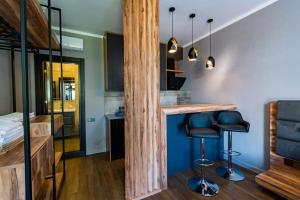a room with a bar with stools and a bed at Dachis Villa Private Pool Retreat in Batumi
