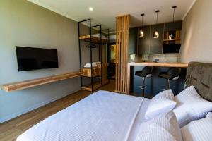 a bedroom with a bed and a kitchen with a bar at Dachis Villa Private Pool Retreat in Batumi +48 photos