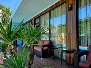 a balcony with a chair and some plants at Dachis Villa Private Pool Retreat in Batumi