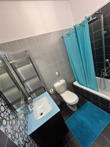 a bathroom with a toilet and a blue shower curtain at Mytilene Luxury Villa Garden Level in Mytilene +44 photos