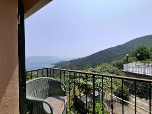 a balcony with a bench and a view of the ocean at Casa vacanza PerlaBlu in Fezzano