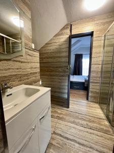 a bathroom with a sink and a mirror at Pensiunea Carina in Bran +55 photos