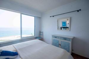 a bedroom with a bed and a view of the ocean at Ferienwohnung am Strand - 2 Schlafzimmer in Arguineguín +34 photos