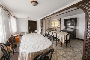 a dining room with tables and chairs and a kitchen at Dujawica in Ząb