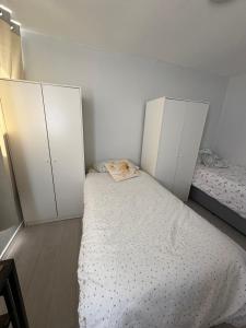 a bedroom with two twin beds and two cabinets at Single bed in mixed shared room in London +9 photos