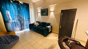 a living room with a green couch and a refrigerator at Regina resort Ain soghna in Ain Sokhna