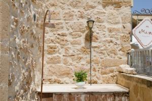 a vase sitting on a table next to a stone wall at La casa della Tonnara, Marzamemi in Marzamemi +42 photos