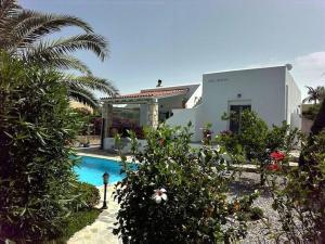 a house with a swimming pool in front of a house at Villa Athina in Pangalochori