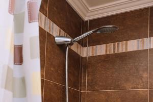 a shower head is attached to a tiled wall at Calma y relax cerca del mar by CABANA Rentals in Ribeira +20 photos