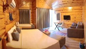 a bedroom with a bed in a log cabin at Taş Konak - DEMRE in Demre