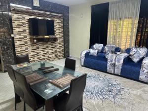 a living room with a table and a couch at Sweet Mum in Malindi +2 photos