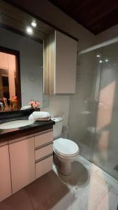 a bathroom with a toilet and a glass shower at Paradise for your family next to Porto Alegre in Eldorado do Sul