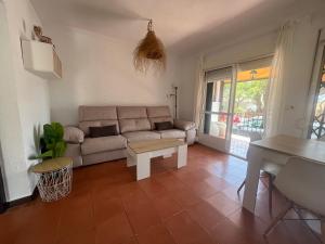 a living room with a couch and a table at PINO BEACH in Punta Umbría