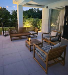 a patio with three benches and a table at Villa Destiny Nedescina, Istrien, Kroatien in Nedeščina +55 photos