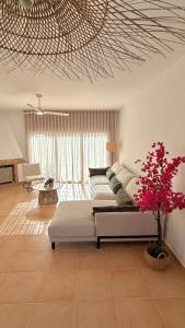 a living room with a couch and a table at Mirador las Cumbres Conil - Piscina Jardín XL in Conil de la Frontera +33 photos