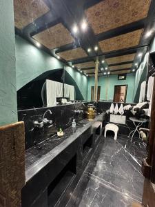 a large bathroom with a sink and a large mirror at Riad DAR tya in Sale +28 photos