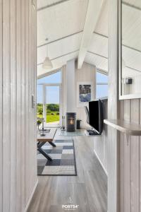 a living room with a fireplace and a television at Ferienhaus Fernblick - Sankt Andreasberg im Harz in Sankt Andreasberg