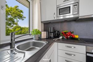 a kitchen with a sink and a microwave at Ferienhaus Fernblick - Sankt Andreasberg im Harz in Sankt Andreasberg +38 photos